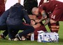 Kevin Strootman recieves attention after injuring his knee in Roma's 1-0 defeat at Napoli