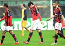 AC Milan players walk off following thier 1-0 defeat to Atletico Madrid