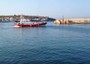 Migranti in arrivo al porto di Lampedusa