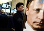 Un operatore di Wall Street e in primo piano l'immagine del presidente russo Vladimir Putin. Le borse hanno sofferto sull'onda della crisi ucraina